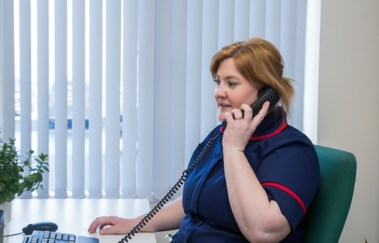 Nurse talking on the phone to patient 