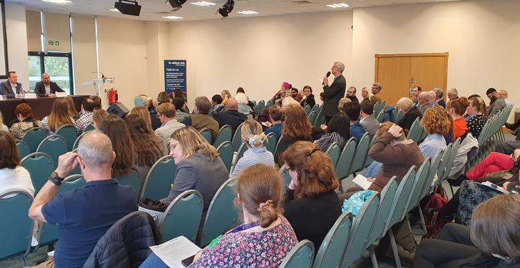 An audience member asks the panel a question during the Q&A session at the Summit.