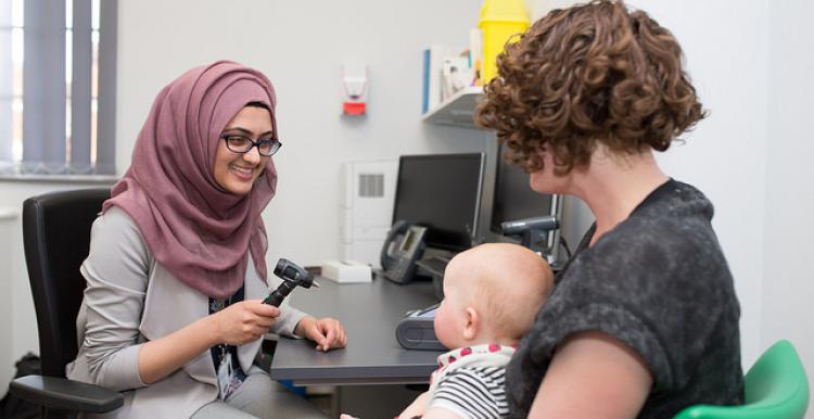 Woman and baby visit GP 