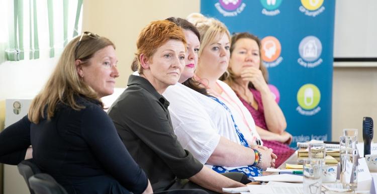 Five women panellists sitting in a row