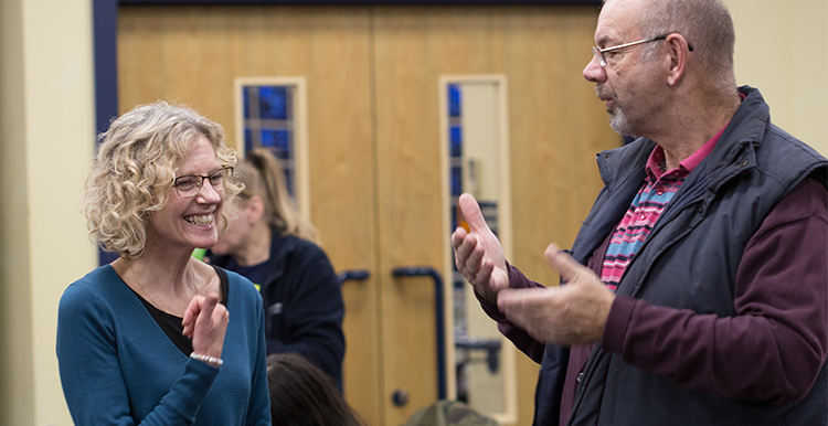 Two people communicating in British Sign Language at a Healthwatch event Deaf people communicating in British Sign Language - accessible information