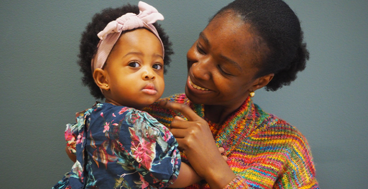 Woman standing holding a baby 