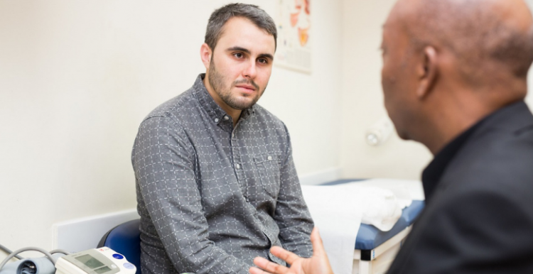 Male patient talking with a GP