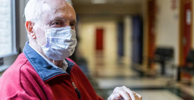 man wearing a face covering in hospital