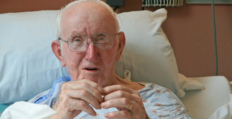 Elderly man in hospital bed