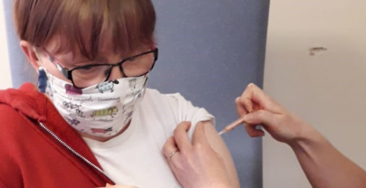 young woman with mask getting her Covid vaccination