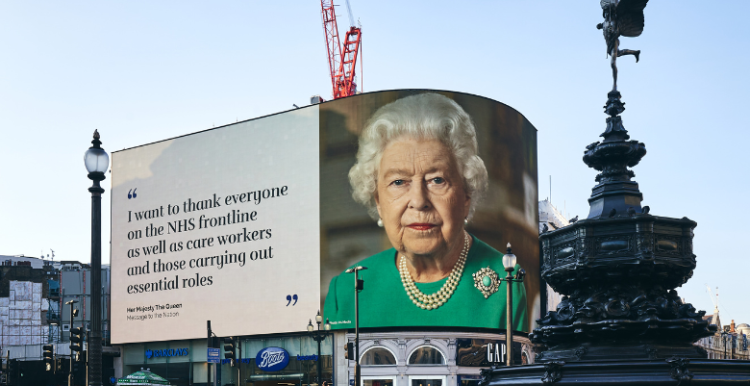 Queen Elizabeth II picture on a banner over Piccadilly Circus in London with a message for health and care workers during the pandemic 