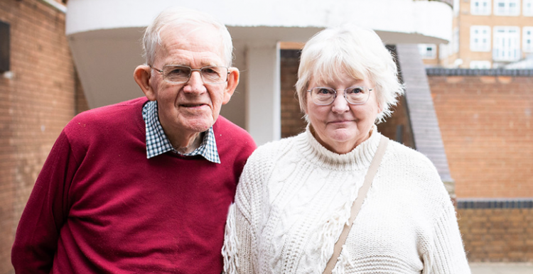 Picture taken at a healthwatch event shows older man and woman looking at the camera
