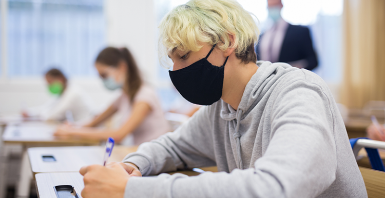 Boy in classroom wearing face covering
