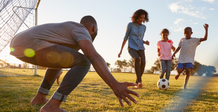 Coronavirus restrictions are being lifted but caution needed to stay safe Family playing football