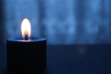 A lit candle in a dark room