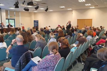 An audience member asks the panel a question during the Q&A session at the Summit.
