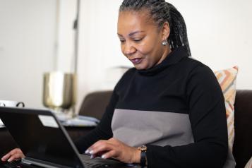 A woman typing on a laptop computer
