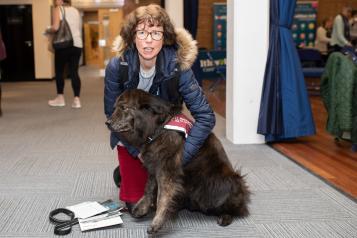 Woman with sensory dog at Healthwatch event 