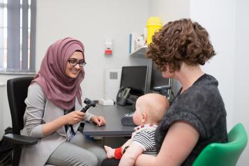 Woman and baby visit GP 