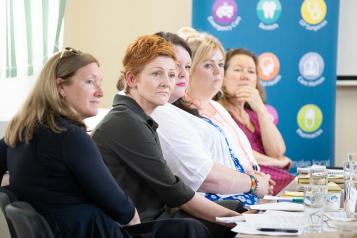 Five women panellists sitting in a row