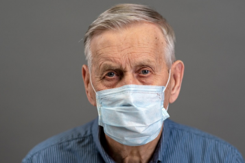 older man wearing a mask