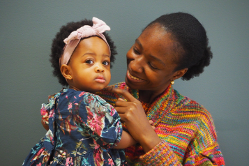 Woman standing holding a baby