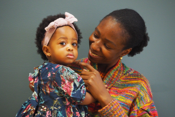 Woman standing holding a baby 