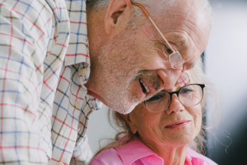 older couple sitting next to one another