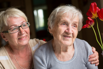 Elderly lady pictured with younger woman and some tulips