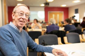 older man smiling into camera