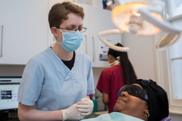 Dentist with patient in examination room