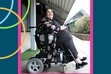 A woman in a wheelchair smiling 