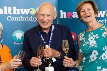 Three people making a farewell toast