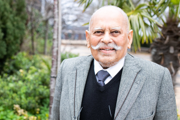 Picture shows older man of South Asian origin looking at the camera 