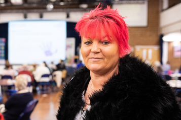 Woman looking at camera at a Healthwatch event