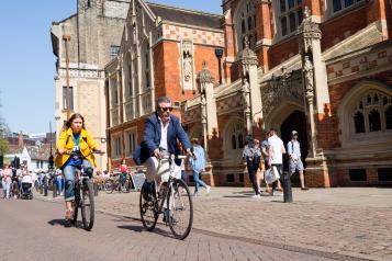 Busy Cambridge street with people cycling and walking 