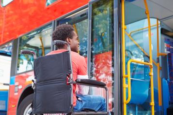 A wheelchair use getting onto a public bus