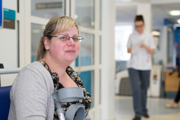 Woman with crutches waiting in hospital 