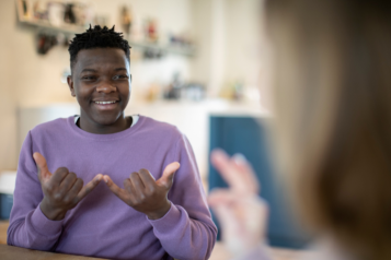 Young person communicating in British Sign Language