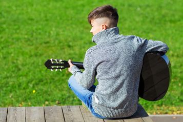 Young person playing guitar