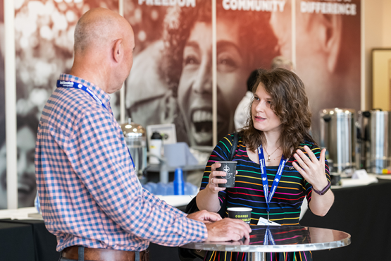 Image shows two Healthwatch Non-Executive Directors in conversation