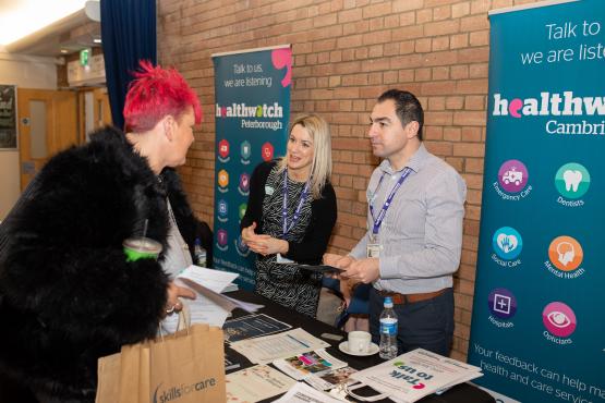 Healthwatch staff talking to people at an event