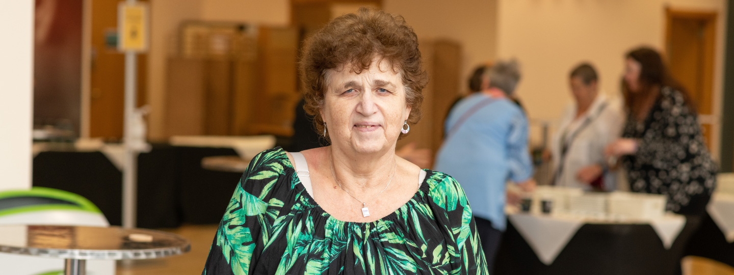 Woman looking at camera at a Healthwatch event 