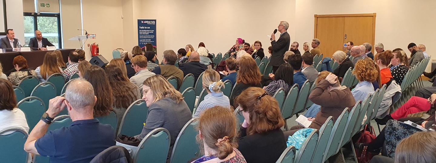 An audience member asks the panel a question during the Q&A session at the Summit.