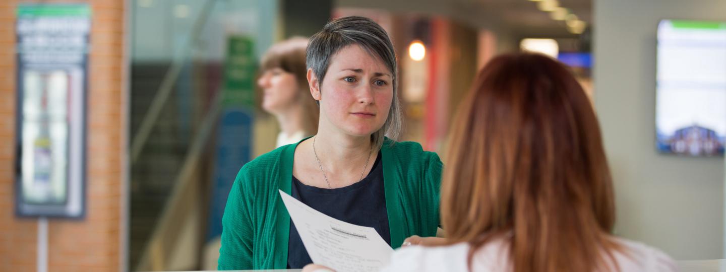 woman at hospital reception desk