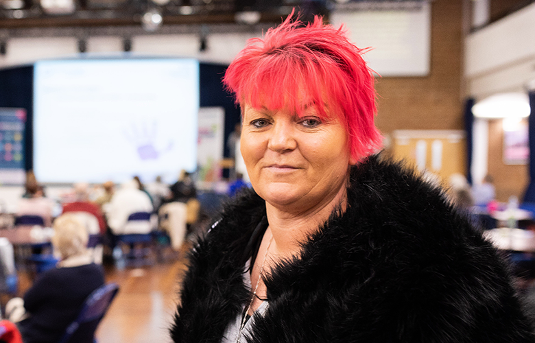 Woman looking at camera at a Healthwatch event 